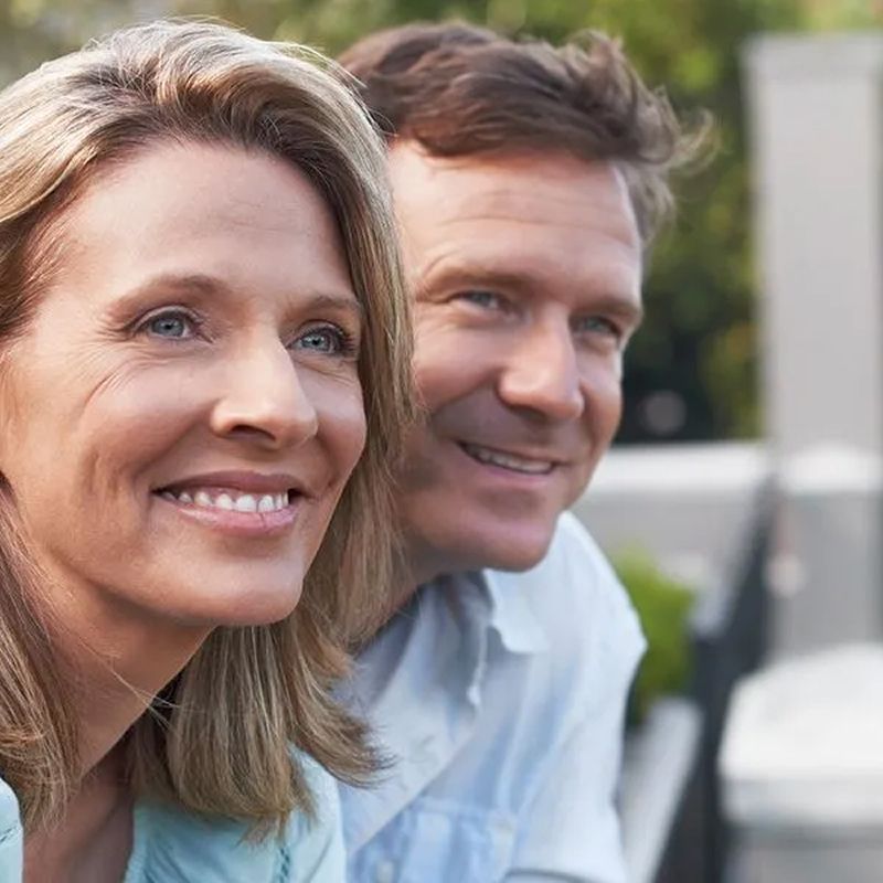 Smiling couple enjoying time together outdoors.